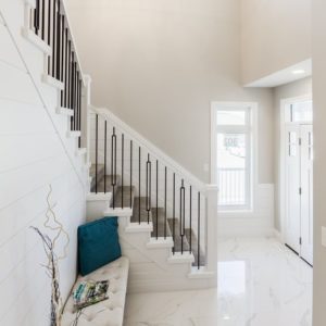 Bright, open foyer with grand staircase by Delonix Homes